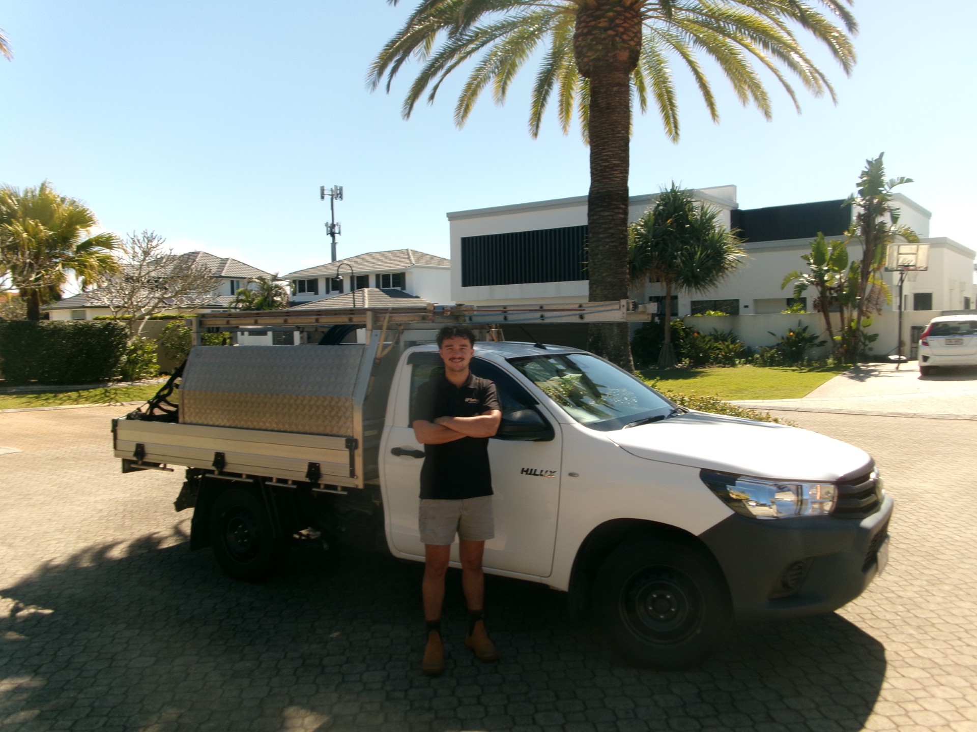 Christian, licensed plumber, beside his service vehicle